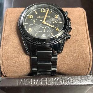 Women’s Black Michael Kors watch with gold details